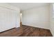 Spacious bedroom featuring wood-look flooring and a large closet with bi-fold doors at 460 Stockwood Dr, Woodstock, GA 30188