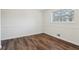 This bright bedroom offers wood-look flooring and a large window at 460 Stockwood Dr, Woodstock, GA 30188
