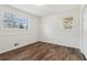 Bedroom featuring wood floors, neutral paint, and large windows at 460 Stockwood Dr, Woodstock, GA 30188