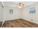 Bedroom featuring wood floors, neutral paint, and a ceiling fan at 460 Stockwood Dr, Woodstock, GA 30188