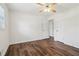 Bright bedroom with wood-look flooring, ceiling fan and convenient door to hallway at 460 Stockwood Dr, Woodstock, GA 30188