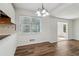 Dining area featuring wood floors, large window, and modern chandelier with access to the kitchen at 460 Stockwood Dr, Woodstock, GA 30188