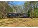 Charming single-story home with well-maintained lawn, trees, and classic exterior details at 460 Stockwood Dr, Woodstock, GA 30188