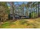 Charming single-story home with well-maintained lawn and classic exterior details, nestled among trees at 460 Stockwood Dr, Woodstock, GA 30188