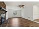 Spacious living room with hard wood flooring, natural light, a ceiling fan, and a beautiful stone fireplace at 460 Stockwood Dr, Woodstock, GA 30188