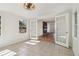 Sunroom looking into the living room with tile flooring, windows, and modern lighting at 460 Stockwood Dr, Woodstock, GA 30188