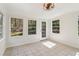 This sunroom features large windows that provide ample sunlight, tile flooring, and neutral paint at 460 Stockwood Dr, Woodstock, GA 30188