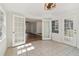 Sunroom leading into the living room featuring large windows, tile floors, and modern lighting at 460 Stockwood Dr, Woodstock, GA 30188