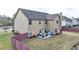 Spacious backyard featuring a patio with outdoor seating and a well-maintained lawn at 9 Oatgrass Dr, Grayson, GA 30017