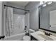 Bathroom with a shower and tub combination, toilet, and single sink vanity with framed mirror at 9 Oatgrass Dr, Grayson, GA 30017