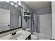 Well-lit bathroom features a shower-tub combination and decorative shelving for practical storage at 9 Oatgrass Dr, Grayson, GA 30017