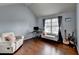 Bedroom area with hardwood floors and featuring a white chair and guitars near the window at 9 Oatgrass Dr, Grayson, GA 30017