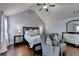 Bedroom features hardwood flooring, a ceiling fan, and nightstands at 9 Oatgrass Dr, Grayson, GA 30017