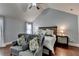 Spacious bedroom features hardwood flooring, ceiling fan, nightstands, and two sitting chairs at 9 Oatgrass Dr, Grayson, GA 30017