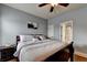 Bedroom features wood floors, queen bed and a doorway to an ensuite bathroom at 9 Oatgrass Dr, Grayson, GA 30017