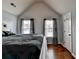 Cozy bedroom with natural light, hardwood floors, and a comfortable bed for relaxation at 9 Oatgrass Dr, Grayson, GA 30017