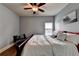 Bedroom featuring wood floors, queen bed, a ceiling fan, and a window with natural light at 9 Oatgrass Dr, Grayson, GA 30017