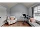 Bedroom area with hardwood floors and featuring a white chair and an electronic drumset at 9 Oatgrass Dr, Grayson, GA 30017