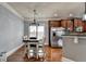 Dining area featuring a table with seating for four, modern light fixture and stainless steel appliances at 9 Oatgrass Dr, Grayson, GA 30017