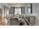 Elegant dining room featuring hardwood floors, wainscoting, tray ceilings, and natural light at 9 Oatgrass Dr, Grayson, GA 30017