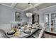 Elegant dining room with tray ceilings, hardwood floors, and stylish chandelier lighting at 9 Oatgrass Dr, Grayson, GA 30017
