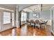 Elegant dining room with tray ceilings, hardwood floors, and stylish chandelier lighting at 9 Oatgrass Dr, Grayson, GA 30017
