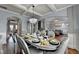 Elegant dining room with tray ceilings, hardwood floors, and stylish chandelier lighting at 9 Oatgrass Dr, Grayson, GA 30017
