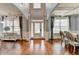 Elegant foyer with hardwood floors, wainscoting, tray ceiling and natural light at 9 Oatgrass Dr, Grayson, GA 30017