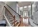 Foyer view showcasing the wooden stairs, hardwood floors and entrance door at 9 Oatgrass Dr, Grayson, GA 30017