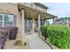 Inviting front porch with decorative columns, landscaping, and an outdoor seating area at 9 Oatgrass Dr, Grayson, GA 30017
