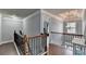 Hallway on the second floor with wood floors, a staircase, and modern chandelier at 9 Oatgrass Dr, Grayson, GA 30017