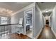 Hallway leading to a bathroom and laundry room with an open view to the foyer below at 9 Oatgrass Dr, Grayson, GA 30017