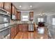 Gourmet kitchen featuring stainless steel appliances, modern finishes, and a seamless connection to the living room at 9 Oatgrass Dr, Grayson, GA 30017