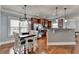 Eat in kitchen area featuring modern lighting, stainless steel appliances, and access to the living room at 9 Oatgrass Dr, Grayson, GA 30017