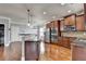 Bright kitchen features stainless steel appliances, pendant lighting, granite countertops, and hardwood floors at 9 Oatgrass Dr, Grayson, GA 30017
