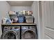 Laundry area with two washers, a dryer and shelving for storage at 9 Oatgrass Dr, Grayson, GA 30017