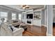 Bright living room with custom built-ins, a fireplace, and comfortable seating at 9 Oatgrass Dr, Grayson, GA 30017