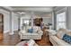 Open layout of living room flows to dining and kitchen with beautiful hardwood floors at 9 Oatgrass Dr, Grayson, GA 30017