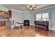 Comfortable living room with hardwood floors, a fireplace, ceiling fan, and a piano at 9 Oatgrass Dr, Grayson, GA 30017