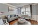 Cozy living room with hardwood floors, neutral wall paint, floor lamp and comfortable seating at 9 Oatgrass Dr, Grayson, GA 30017