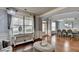 Open floor plan view of living room showcasing hardwood floors, a window, and dining room in the background at 9 Oatgrass Dr, Grayson, GA 30017
