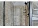 Tiled shower with black shower head and shampoo shelves at 9 Oatgrass Dr, Grayson, GA 30017