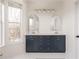 Bathroom features double sinks, navy blue vanity, gold fixtures, and large window for natural light at 951 Glenwood Se Ave # 3104, Atlanta, GA 30316