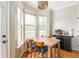 Bright dining nook with wood table, blue chairs, bay window, and beverage center at 951 Glenwood Se Ave # 3104, Atlanta, GA 30316