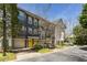 Townhouse exterior view showcasing gray facade, yellow doors, and well-maintained landscaping in a residential neighborhood at 951 Glenwood Se Ave # 3104, Atlanta, GA 30316