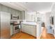 Bright kitchen featuring stainless steel appliances, sage green cabinets, and open layout to living area at 951 Glenwood Se Ave # 3104, Atlanta, GA 30316