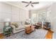 Bright living room features large bay window, hardwood floors, decorative panel wall, and modern furnishings at 951 Glenwood Se Ave # 3104, Atlanta, GA 30316