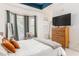 Modern main bedroom with tray ceiling, bay window, hardwood dresser, and serene color palette at 951 Glenwood Se Ave # 3104, Atlanta, GA 30316