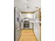 A sunlit kitchen with a stainless steel refrigerator and oven, and white cabinets at 1101 Juniper Ne St # 922, Atlanta, GA 30309