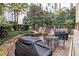 Charming outdoor patio with barbecue grills, dining tables, and lush landscaping at 1101 Juniper Ne St # 922, Atlanta, GA 30309